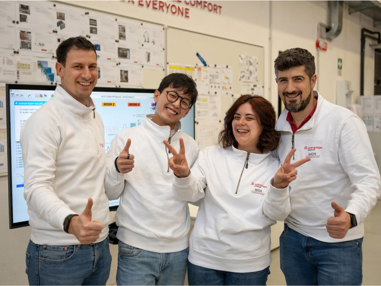 Four Ariston employees smiling.